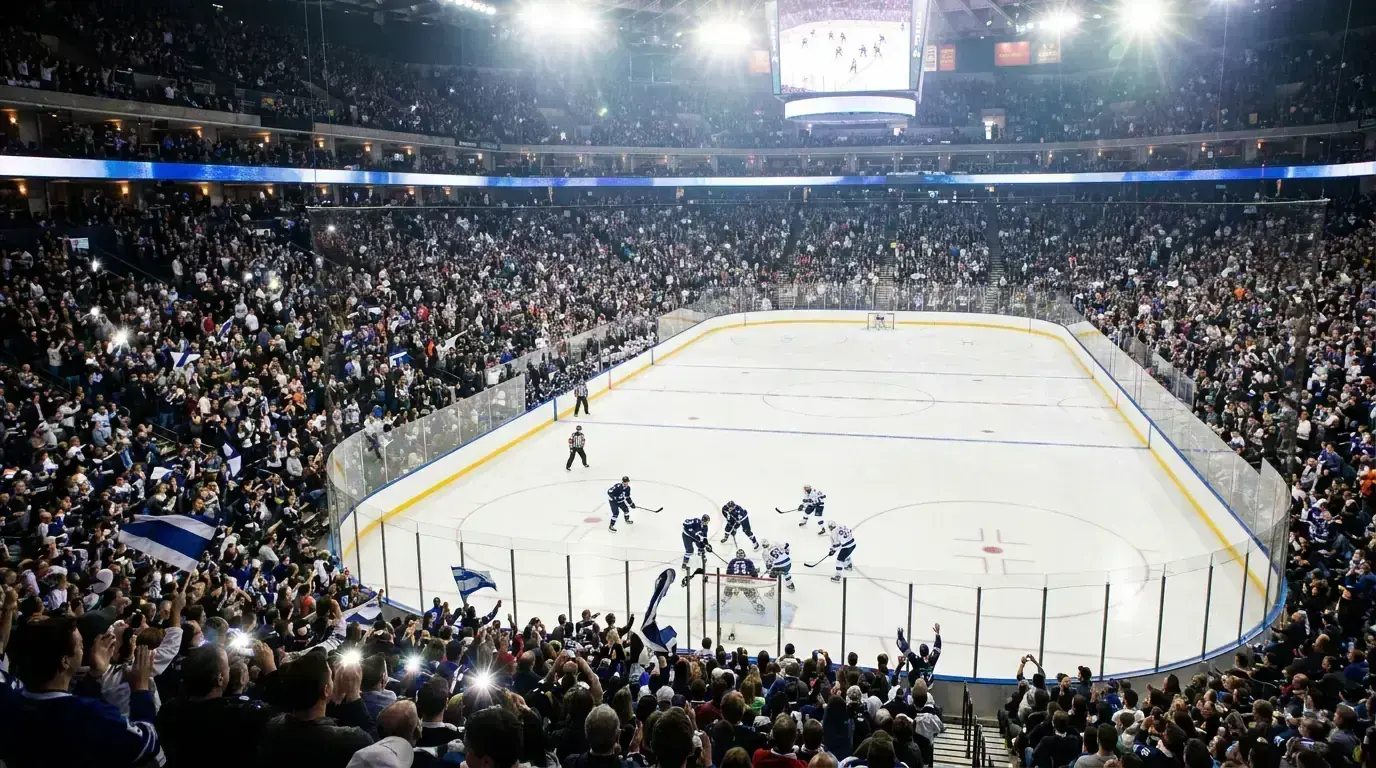 Ice hockey arena during a professional game with players on the rink and crowd in the stands