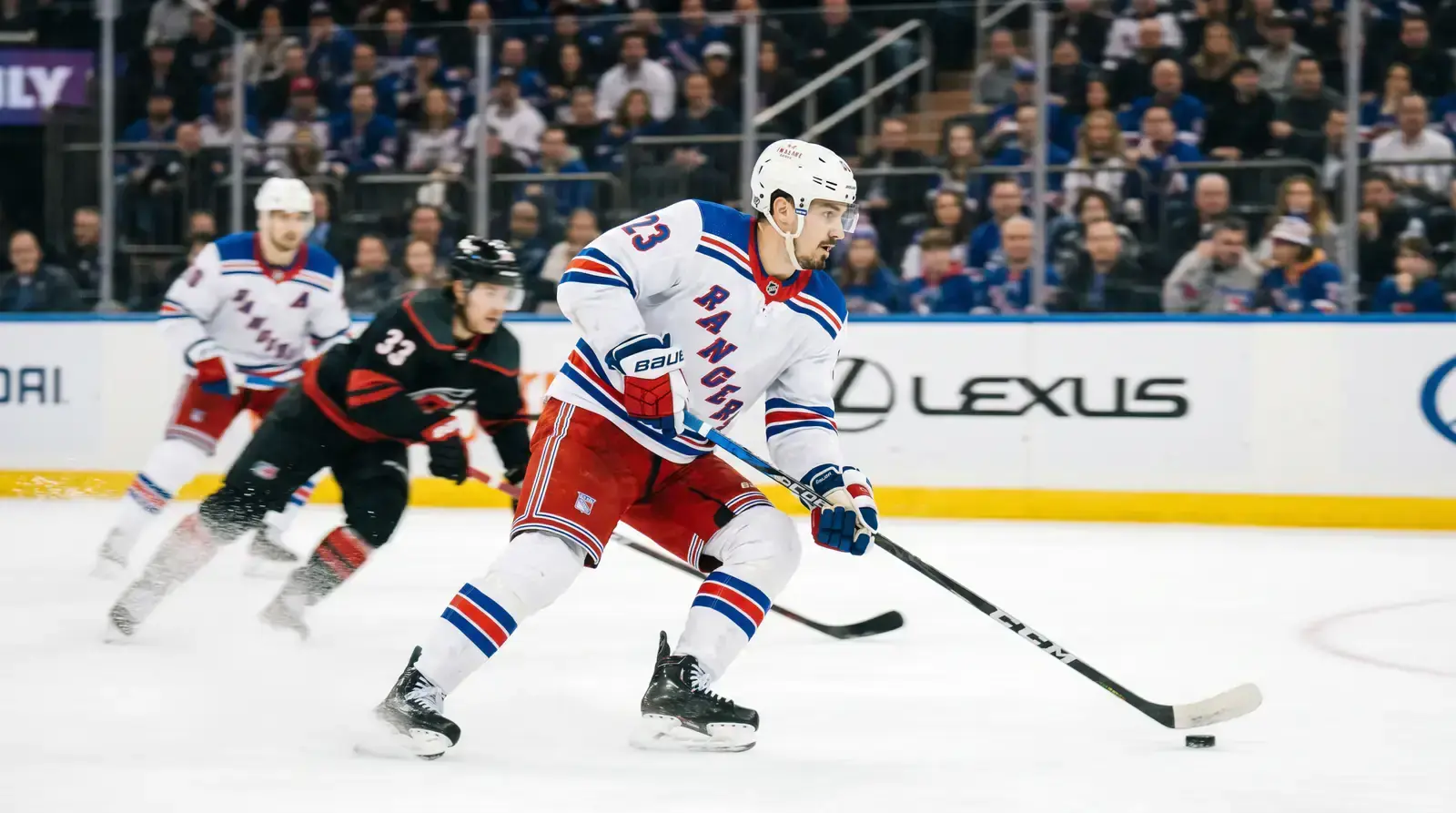 NHL forward skating through the neutral zone with the puck during a fast break