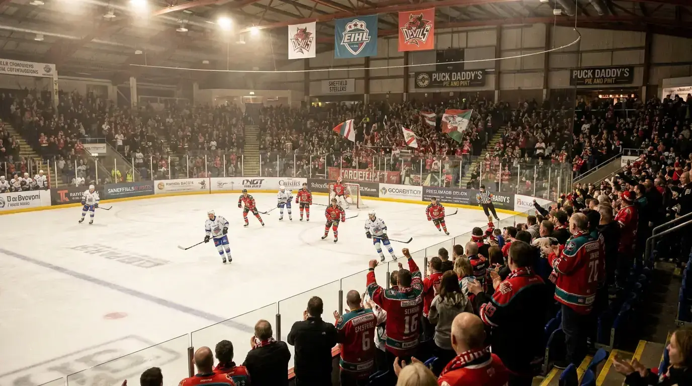 EIHL game in progress at a British ice hockey arena with enthusiastic fans