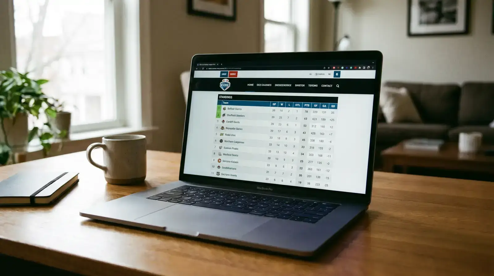 Laptop showing EIHL standings and team statistics on the league website