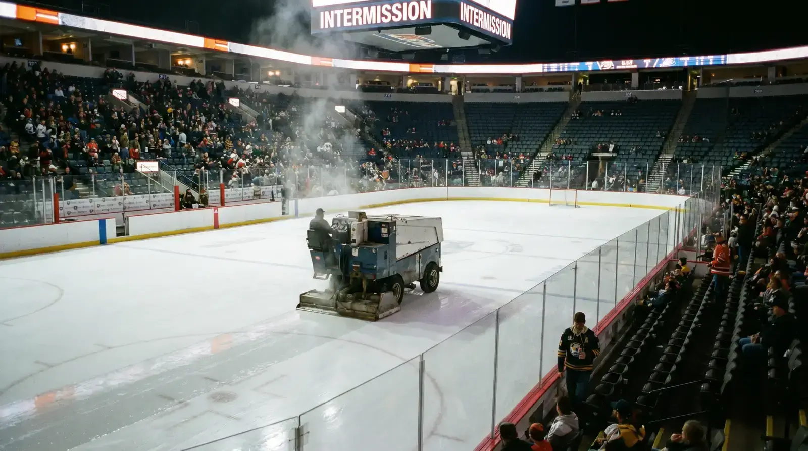 Hockey arena during intermission with Zamboni resurfacing the ice