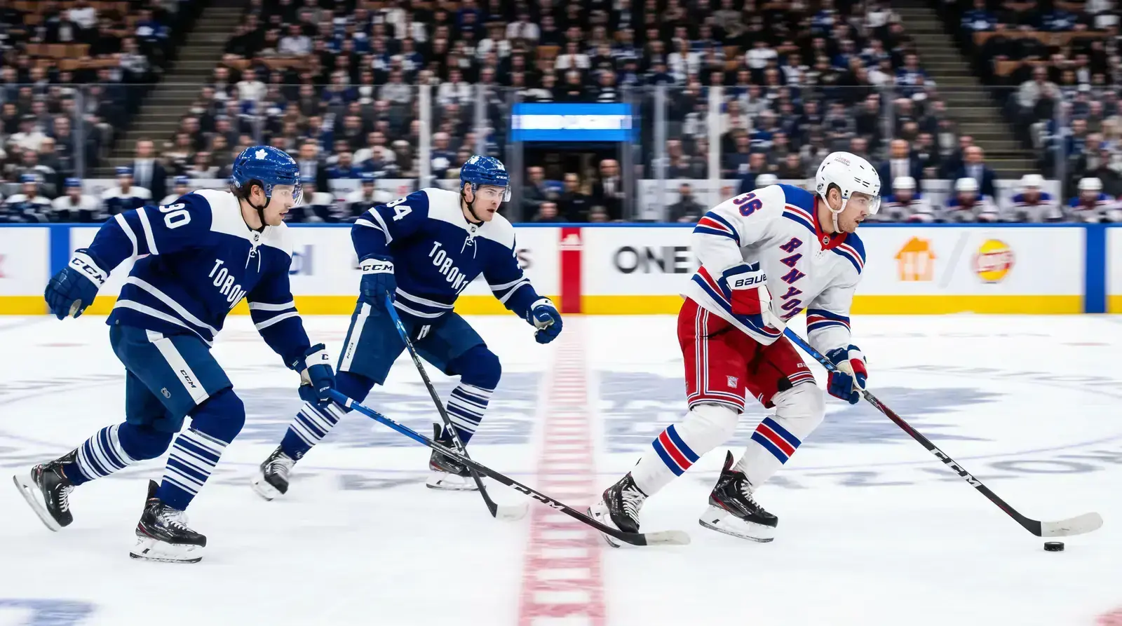 NHL players skating at full speed during a regular season game under arena lights