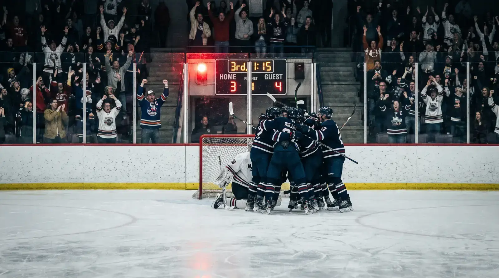 Third period action with players battling in front of the net for a goal