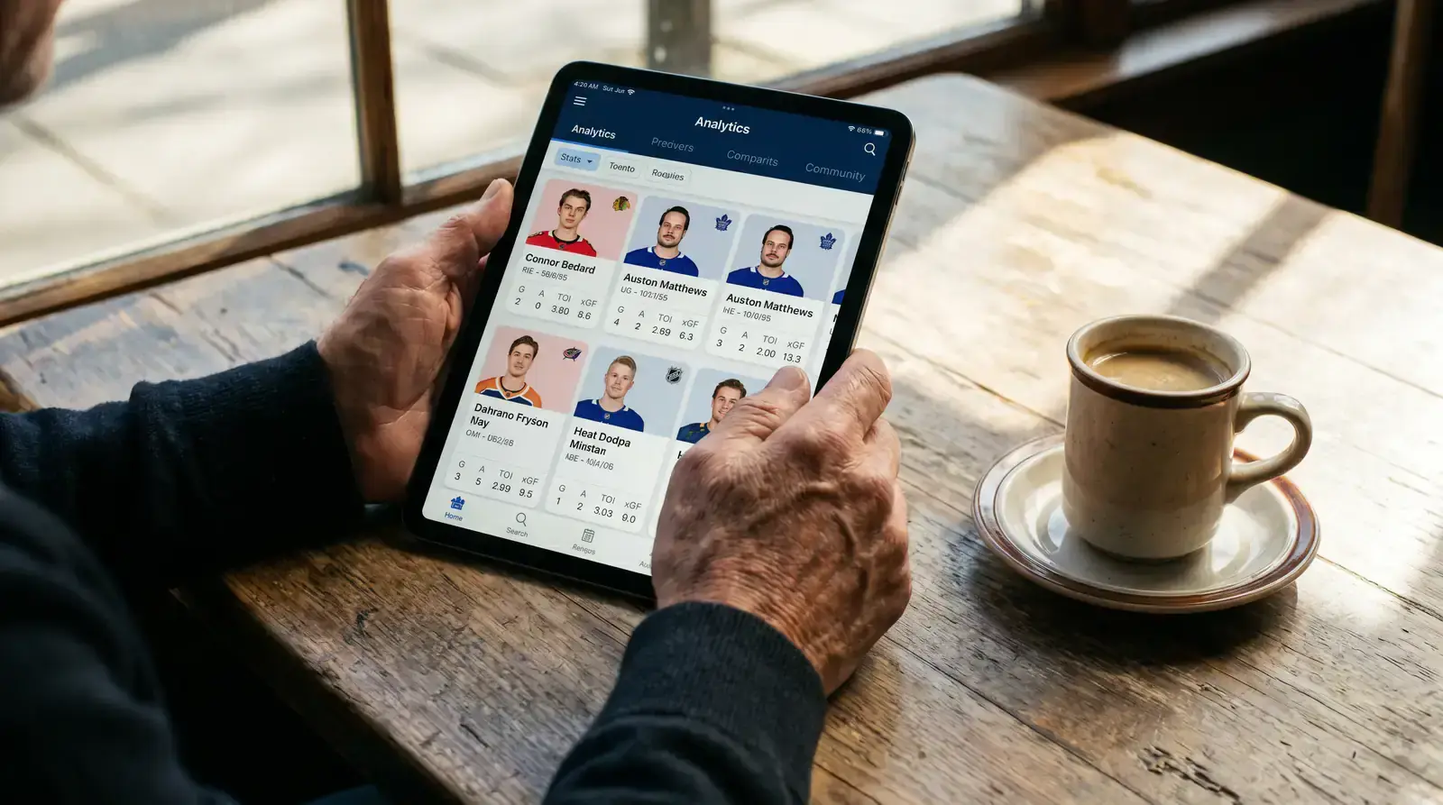 Person comparing hockey player statistics on a tablet before placing a bet