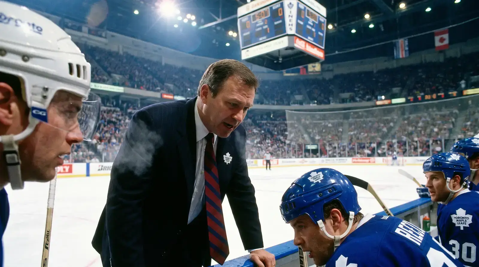 Hockey coach and players on bench reviewing strategy during a game stoppage