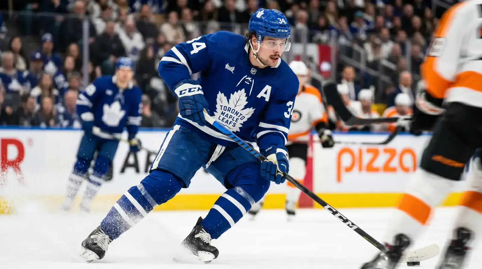 NHL player skating at speed through the neutral zone during a game